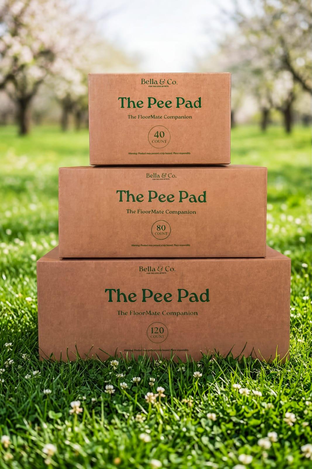 Plant-based Pee Pad boxes stacked in the grass